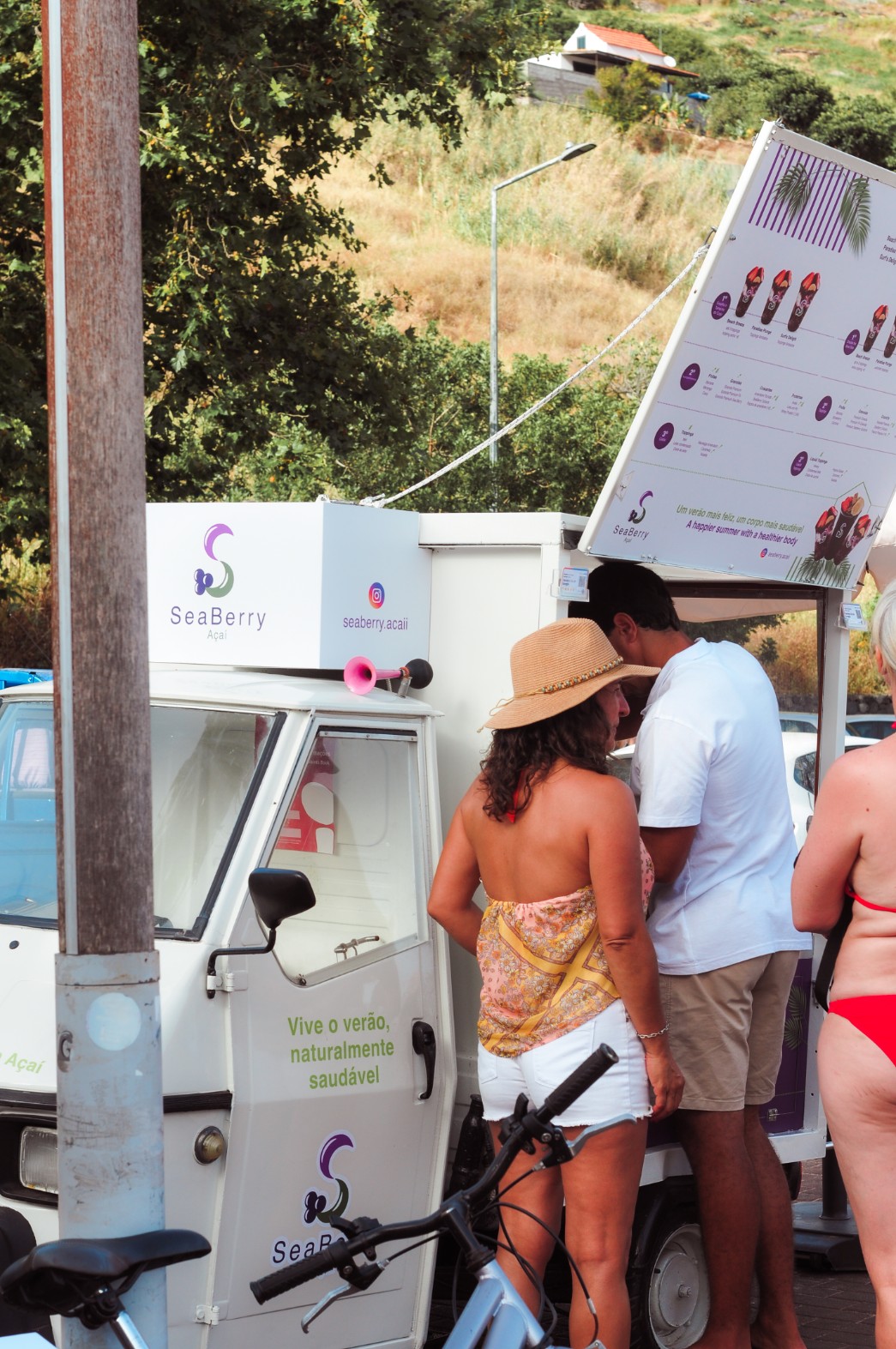 Team member serving açaí at the Machico beach stand